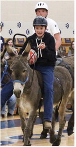 Students, Donkeys Entertain Crowd In Bainville